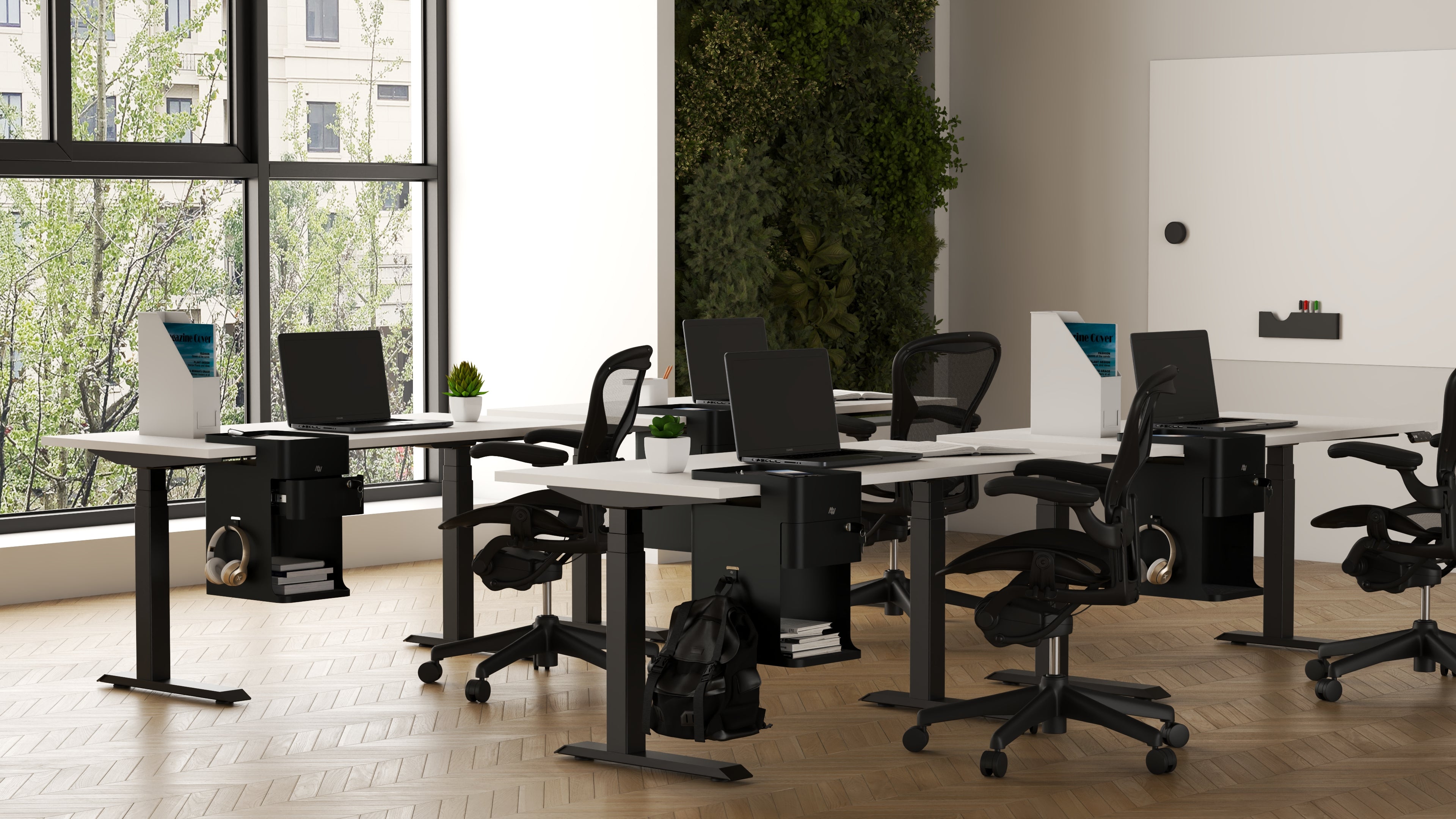 Modern office setup with desks, chairs, and large windows.